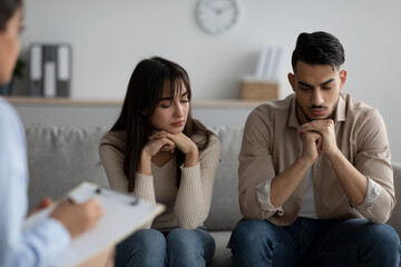 Marital psychotherapy. Arab spouses with relationship problems sitting at therapy session with psychologist - obrazy, fototapety, plakaty
