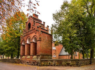Fototapeta na wymiar Built in the years 1477-1507 in the Gothic and Neo-Baroque styles, the historic Catholic Church of Our Lady of the Rosary with a belfry in the city of Drobin in Mazovia, Poland.
