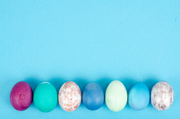 Decorated handmade Easter eggs for the holiday season on blue background. Creative minimal abstract concept. Studio Photo