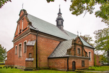 Naklejka premium Built in the years 1477-1507 in the Gothic and Neo-Baroque styles, the historic Catholic Church of Our Lady of the Rosary with a belfry in the city of Drobin in Mazovia, Poland.