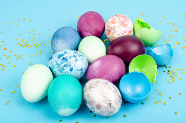 Decorated handmade Easter eggs for the holiday season on blue background. Creative minimal abstract concept. Studio Photo