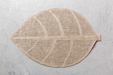 Obraz premium Perspective view of leaf shaped tablecloth for food on cement background. Empty space for your design.