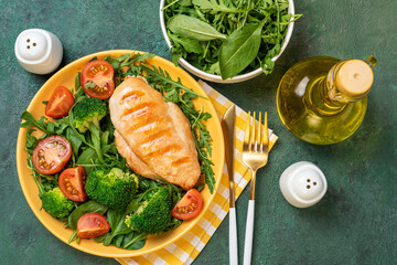 Cooked chicken fillet with fresh vegetable salad. Chicken breast and green vegetables, broccoli on table. Healthy food, keto diet concept. Healthy lunch menu
