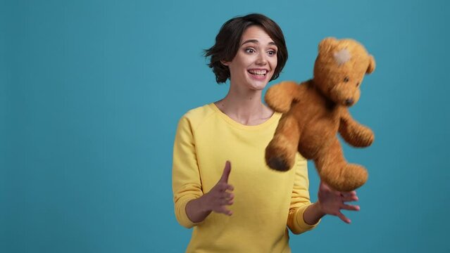 Childish lady catch stuffed animal toy present isolated blue color background