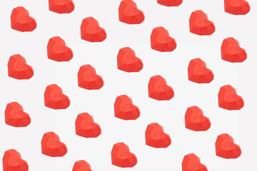 Fototapeta na wymiar Valentine's Day love creative pattern made of neatly arranged red hearts on white background. Aesthetic artistic.