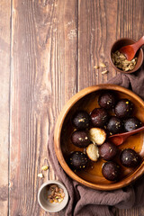 Sweet Gulab Jamun in wooden bowl on rustic background