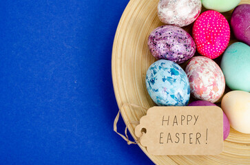 Decorated handmade Easter eggs for the holiday season on blue background. Creative minimal abstract concept. Studio Photo