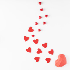 Valentine's Day.love creative composition of different sizes red hearts arranged from largest to smaller on white background. Flat lay. Copy space.