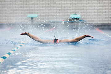 Professional male swimmer swimming in the pool