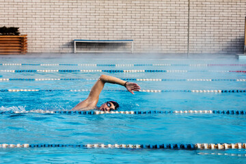 Professional male swimmer swimming in the pool