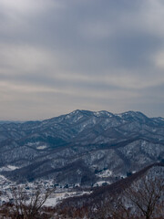 Fototapeta na wymiar Snowy Mountainscape from the top of Mount Sapporo in Hokkaido, Japan 