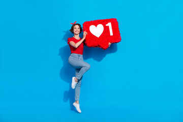 Full length photo of young pretty woman jump energetic advertise click app subscribe isolated over blue color background