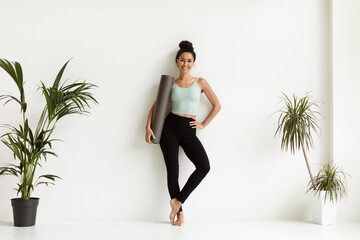 Fitness Lifestyle. Happy Lady In Sportswear Posing With Yoga Mat In Hands
