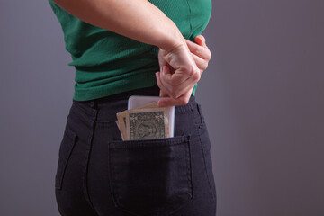 young girl puts money in her pocket