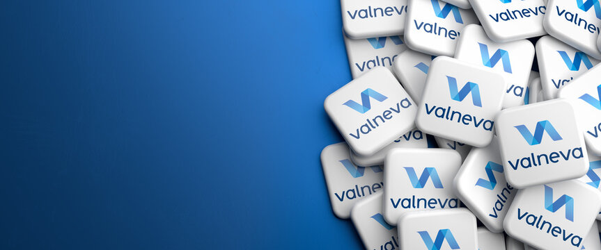 Logos Of The French Biotechnology Company Valneva On A Heap On A Table. Copy Space. Web Banner Format.