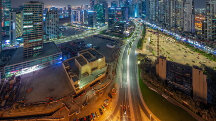 Fototapeta na wymiar Water canal with modern towers residential development in Business Bay aerial panoramic night timelapse, Dubai