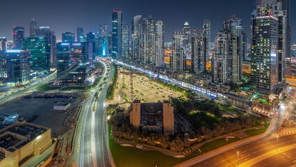 Fototapeta na wymiar Bay Avenue with modern towers residential development in Business Bay aerial panoramic all night timelapse, Dubai