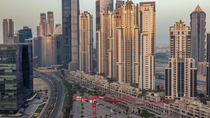 Naklejka na ściany i meble Bay Avenue during sunrise with modern towers in Business Bay aerial timelapse, Dubai
