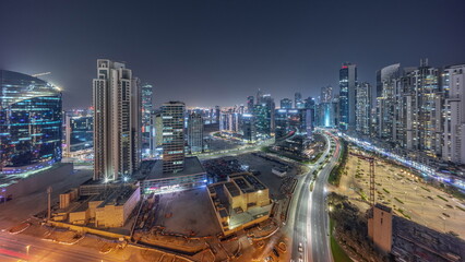 Fototapeta na wymiar Bay Avenue with modern towers residential development in Business Bay aerial panoramic night timelapse, Dubai