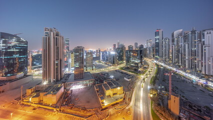 Fototapeta na wymiar Bay Avenue with modern towers residential development in Business Bay aerial panoramic night to day timelapse, Dubai