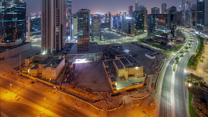 Fototapeta na wymiar Business Bay Dubai skyscrapers with water canal aerial night to day timelapse.