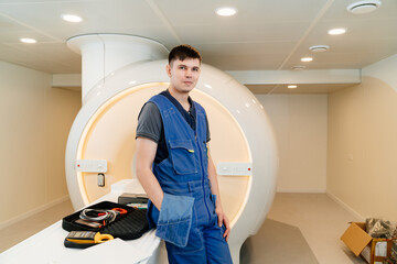 installer engineer of mri apparatus with tools near scanner - obrazy, fototapety, plakaty