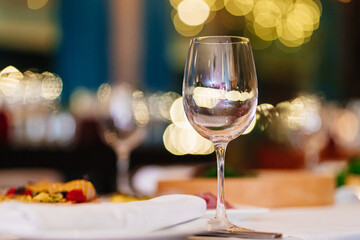 an empty wine glass on the festive table. tableware for restaurants and at home.