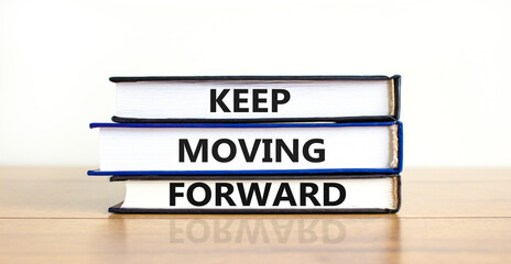 Keep moving forward symbol. Concept words Keep moving forward on books on beautiful wooden table white background. Business, motivation and keep moving forward concept. Copy space.