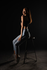 Fototapeta na wymiar Posing on high chair in studio
