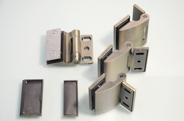 Bronze hinges for glass doors. Glass accessories. Fixings for glass doors. Glass connectors in Brass color.