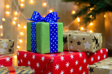 Christmas gift box on bokeh background. Holiday greeting card.