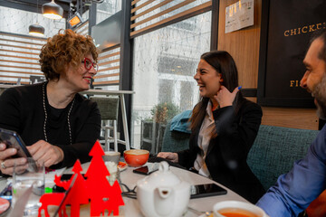 Showing each other something on the phone and laughing