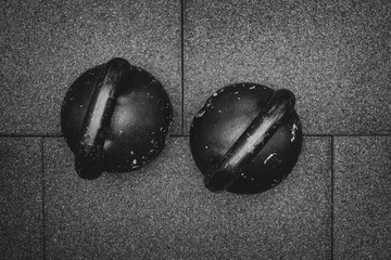  Sports weights, black iron kettlebell for weight training.  Fitness workout center. Sport concept. Flat lay. black and white photography