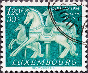 Luxembourg - circa 1954: a postage stamp from Luxembourg, showing Carousel Horses