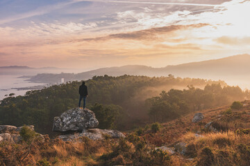 Beautiful landscape with a man on a rock