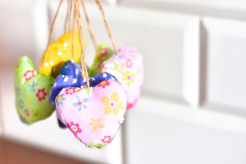 delicate hearts in flowers, sewn with your own hands from fabric on strings, as a decoration for the holiday