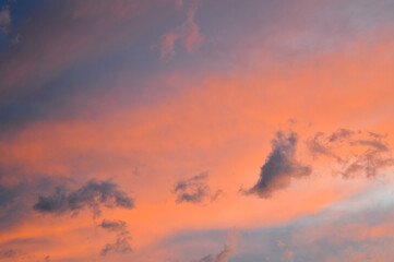 Dreamy cloudy sky at sunset with beautiful pink and orange colors, nature background