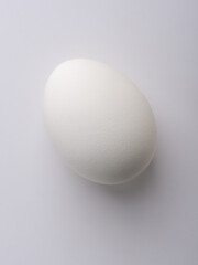 Light and shadow on a chicken egg. Light on the sharp end of the egg.