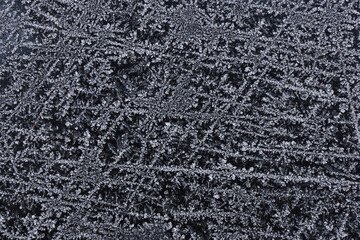 Frozen pattern of hoarfrost and frostwork structure on the dark glass. Color photo for background. No2.