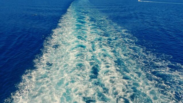 Wake of a ship trail, on sea with cloudy sky, moving, travel, going.