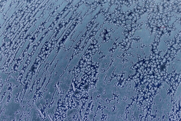 Obraz premium Frozen pattern of hoarfrost and frostwork structure on the glass. Color photo for background. No2.