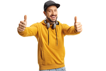 Fototapeta premium Smiling young man with headphones showing both thumbs up
