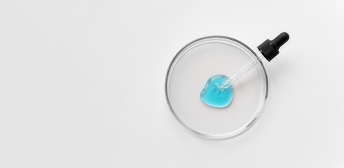 Banner of Laboratory glass petri with pipette and blue drop of serum, oil, beauty product. Natural medicine, cosmetic research, bio science. Concept of skincare and analysis. Dermatology. Top view