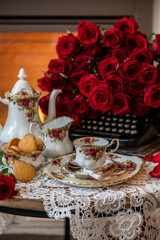 English style high tea, vintage still life, porcelain tea cup, coffee set with red roses. happy valentines day