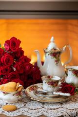 English style high tea, vintage still life, porcelain tea cup, coffee set with red roses. happy valentines day