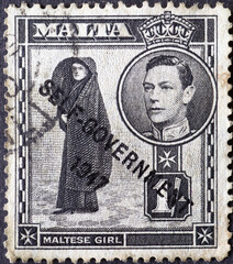 Malta - circa 1948: a postage stamp from Malta , showing a Maltese Girl and a portrait with King...