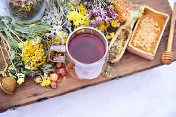 Tea from the collection of medicinal herbs and honey on a background of snow. Healthy food, winter...