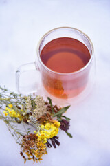 Tea from the collection of medicinal herbs and honey on a background of snow. Healthy food, winter...