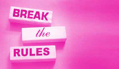 Break the rules phrase on wooden blocks on dark grey. Behavior concept or innovative business...