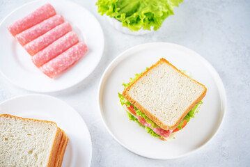Sandwich with sausage, cheese and tomato for lunch